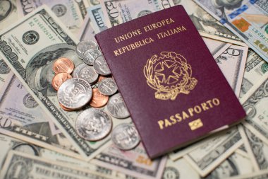 Italian Passport on top of US Dollar banknotes and coins. Travel to the United States of America. Italy Identification Passport. Travel Expenses