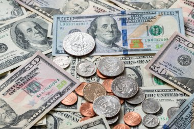 Half Dollar coin on Dollar Banknotes and differed USD coins. American Currency. Federal Reserve