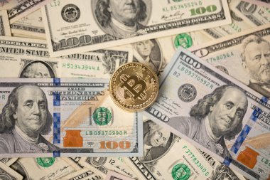 100 dolarlık banknotlarda birikmiş bitcoin 'ler. Şifreli para birimleriyle arka plan olarak dolar. Dolar kavramı ile dijital para değişimi
