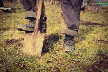 Bir adam kürekle toprağı kazıyor. Çalışanım. Çalış. Toprak Çalışması.