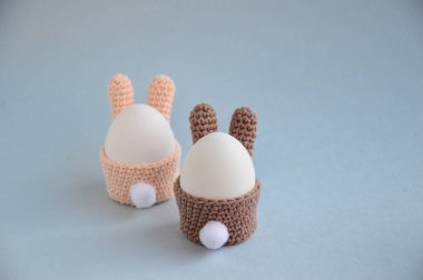 Paskalya tatili hazırlığı. Kuyruklu bir Paskalya tavşanı şeklinde örülmüş yumurta sepeti. Yumurta tavşancık şeklinde duruyor. Beyaz yumurta. Kartpostal Kendi ellerinle çocuklarla el sanatları yapıyorsun.