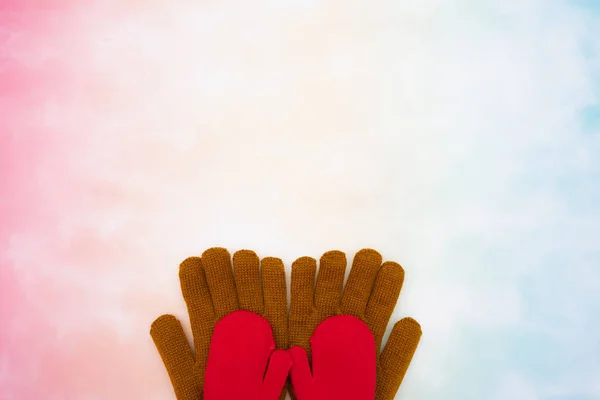 Represent family scene of dad holds child hands at bottom with colorful background. Represent child and father by unbranded gloves