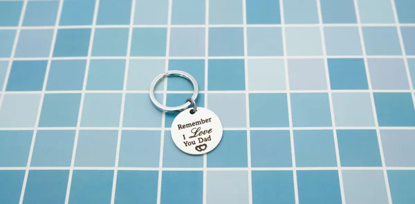 Keychain gift from child in father's day on blue table