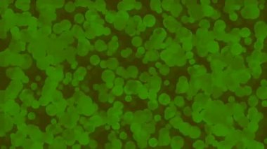 Kahverengi arka planda hareket eden yeşil baloncukların yer aldığı soyut animasyon dinamik ve organik bir görsel etki yaratıyor.