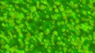 Yüzen ve dönen yeşil kabarcıkların soyut animasyonu dinamik ve organik bir arkaplan oluşturur..