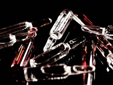 Tıbbi ampuller kapanıyor. Bir sürü ampul. Masada cam ampuller var. İlaç ile dağılmış ampuller.