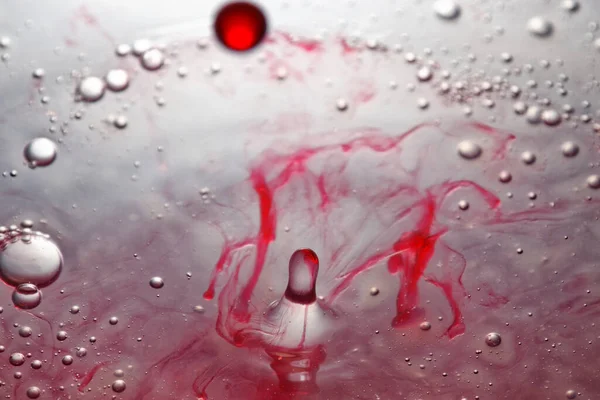 Colored water drop, circle ripples, splash of water, closeup.