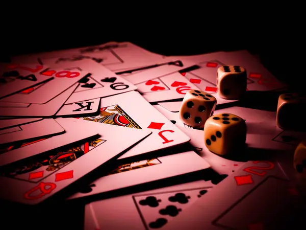 Dice and playing cards, black background