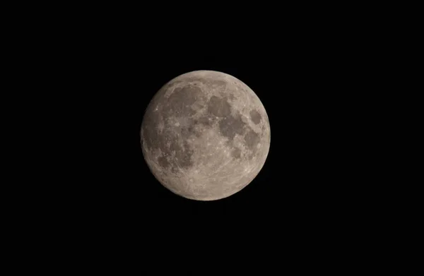 Earth\'s Moon Glowing On Black Background