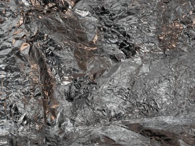 Parlak, düz olmayan yüzeyi olan gümüş yapraklı ince bir zemin.