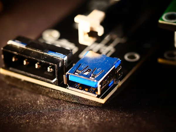 Riser for mining on video card. Device for collecting a mining farm. Mining board.Microcircuit for connecting video card. Selective focus. Macro.