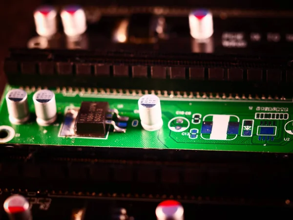 Riser for mining on video card. Device for collecting a mining farm. Mining board.Microcircuit for connecting video card. Selective focus. Macro.