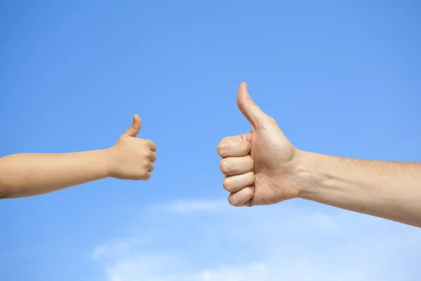 Father and son hands giving like on sky background — Stock Photo, Image