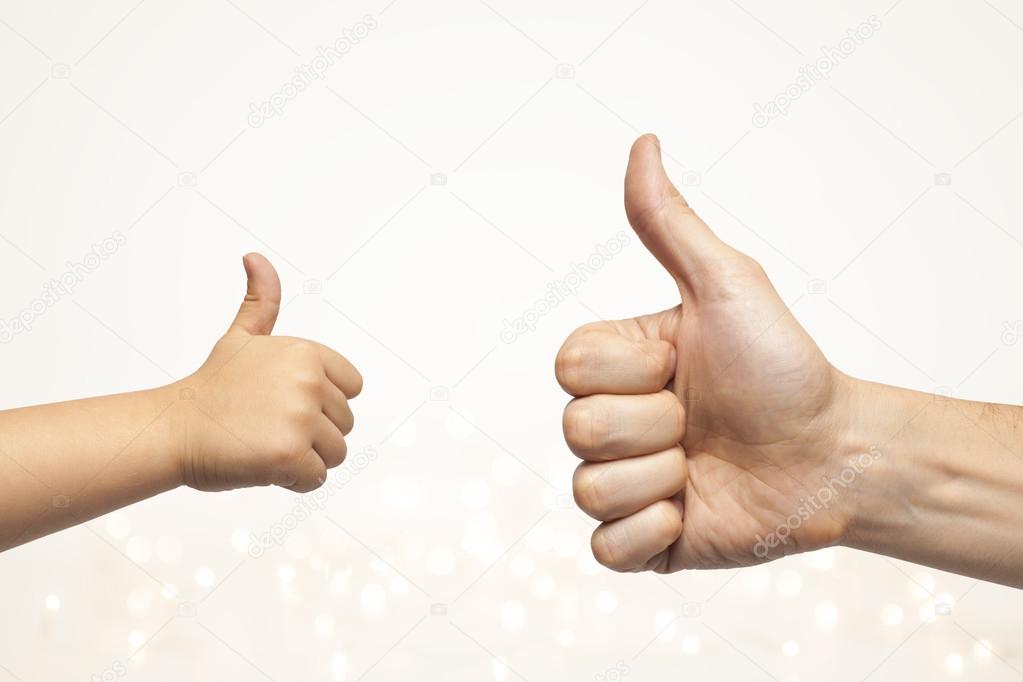 Father and son hands giving like on christmas lights background