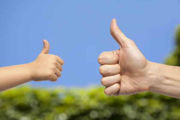 Father and son hands giving like on natural background. — Stock Photo, Image