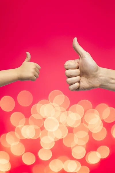 Father and son hands giving like on christmas lights background — Stock Photo, Image