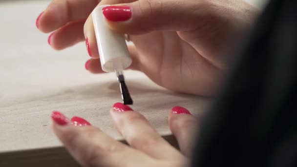 Una joven europea se pinta las uñas con barniz claro — Vídeos de Stock