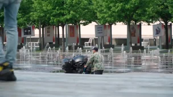 A janitor drives a cart with garbage bags — Stock Video