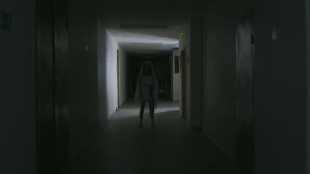 El fantasma de la novia está en el pasillo oscuro y sonríe — Vídeo de stock