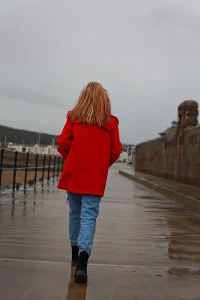 Back of a woman walking away on a wet day — Stock Photo, Image