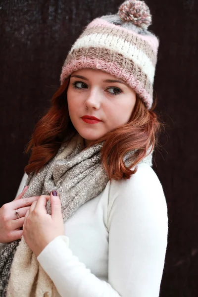 Pretty red headed girl wearing pom pom hat and scarf — Stock Photo, Image