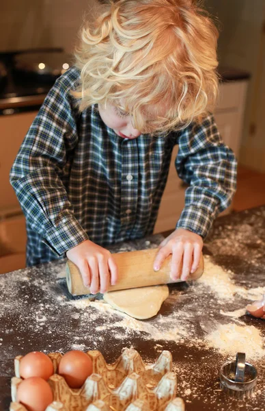 Kleine jongen uitrol van gebak — Stockfoto