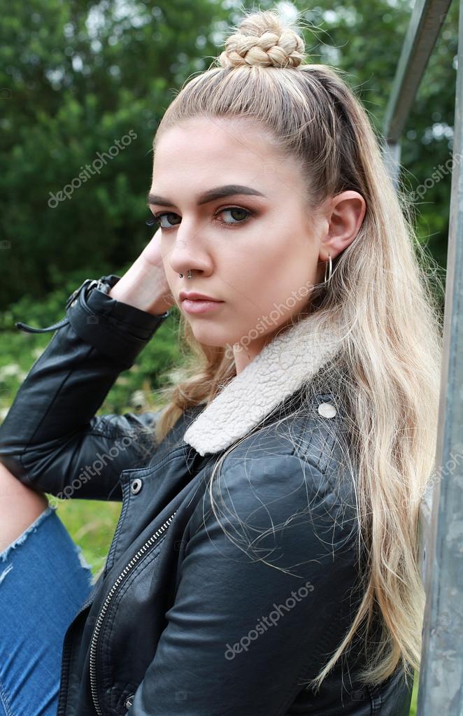 Portrait of a tough looking teenage girl with her nose pierced