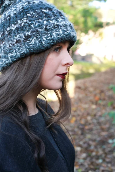 Profile of a beautiful teenage girl wearing a pom pom hat — Stock Photo, Image