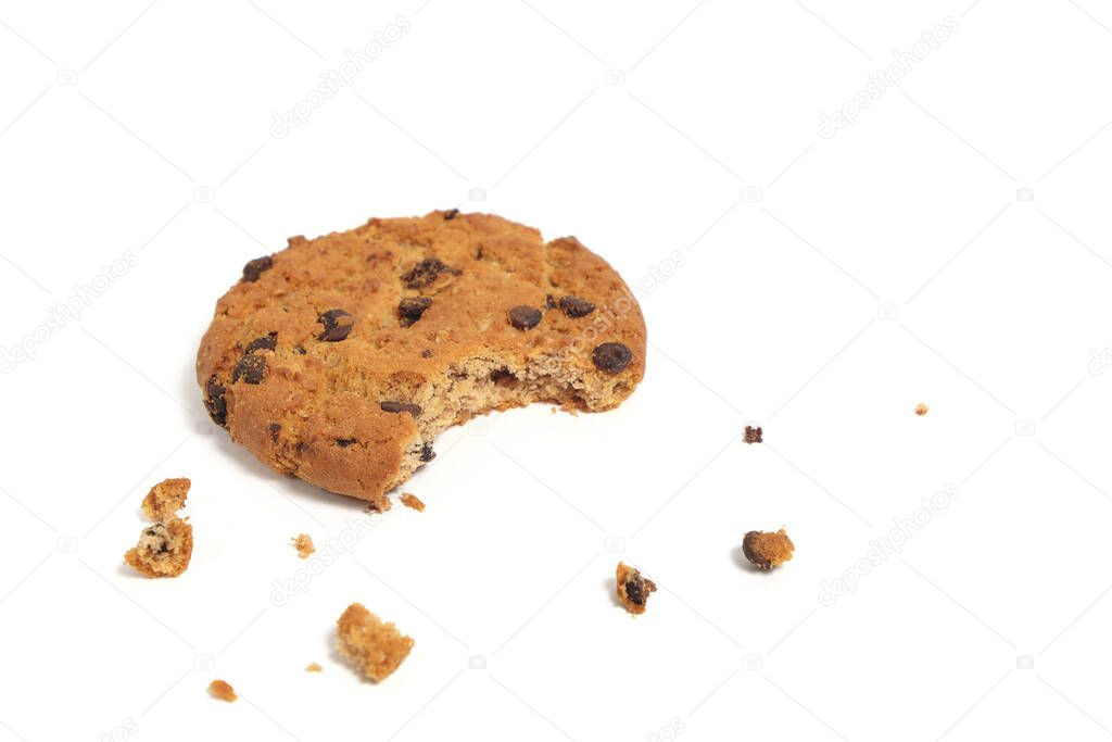 Bitten off chocolate, crumbled homemade cookies on a white background