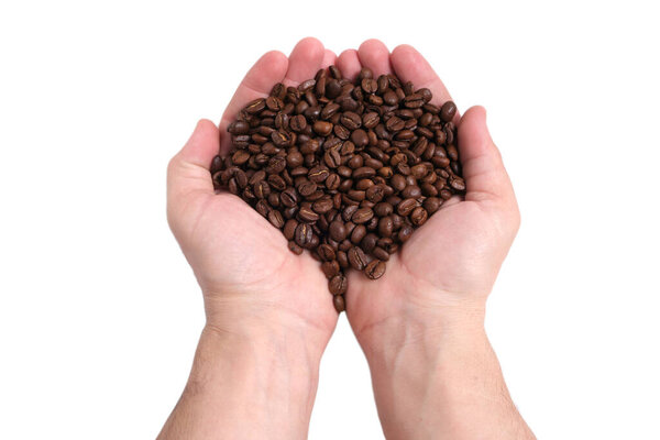 Handful of coffee beans in his hands on a white background of isolate