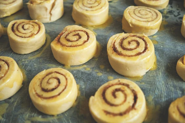 Blanks for baking cinnamon rolls on baking sheet with parchment paper
