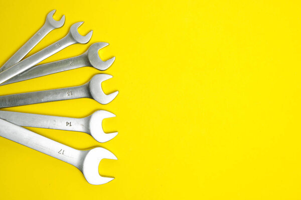 Set of wrenches on a yellow background