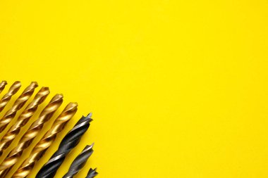 Set of drills for wood and metal on a yellow background