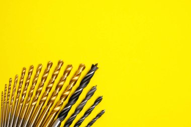 Set of drills for wood and metal on a yellow background