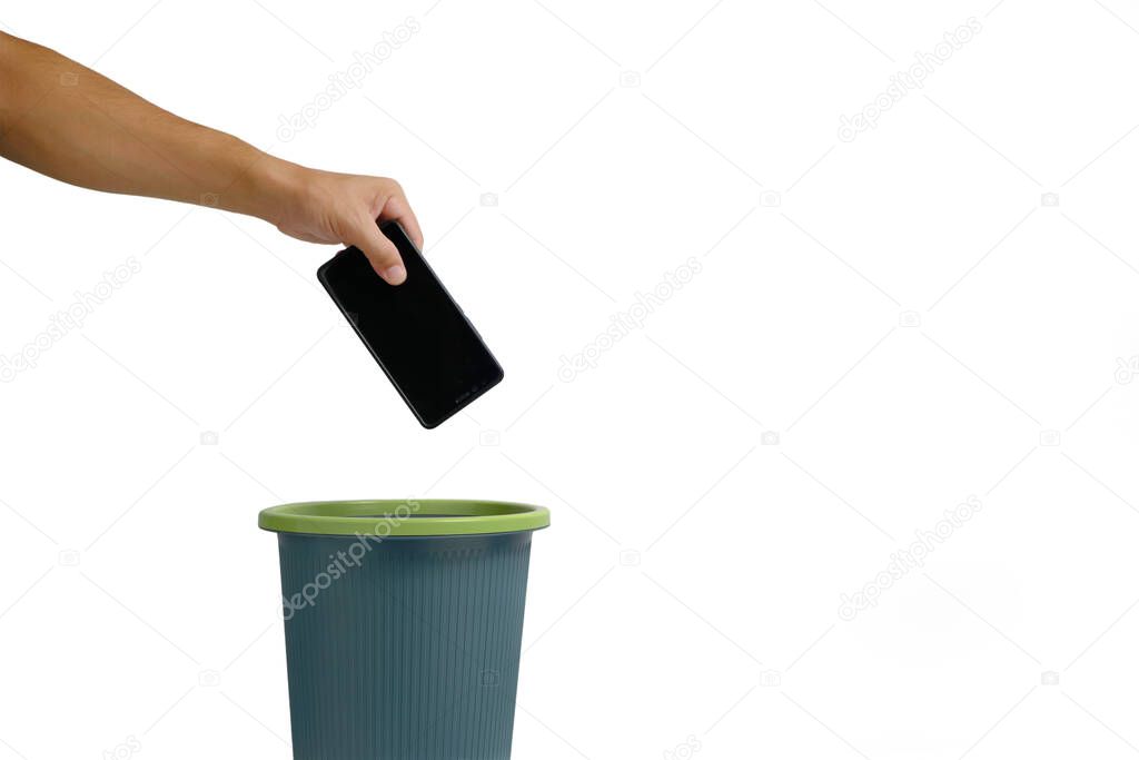 Man hand throws cell phone into trash can on white background