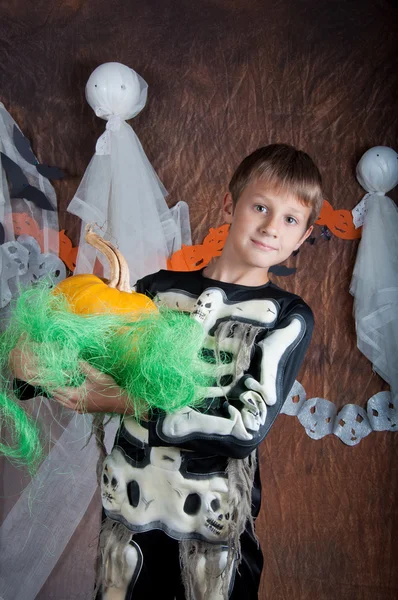 Boy in Halloween costume with orange pumpkin — Stock Photo, Image