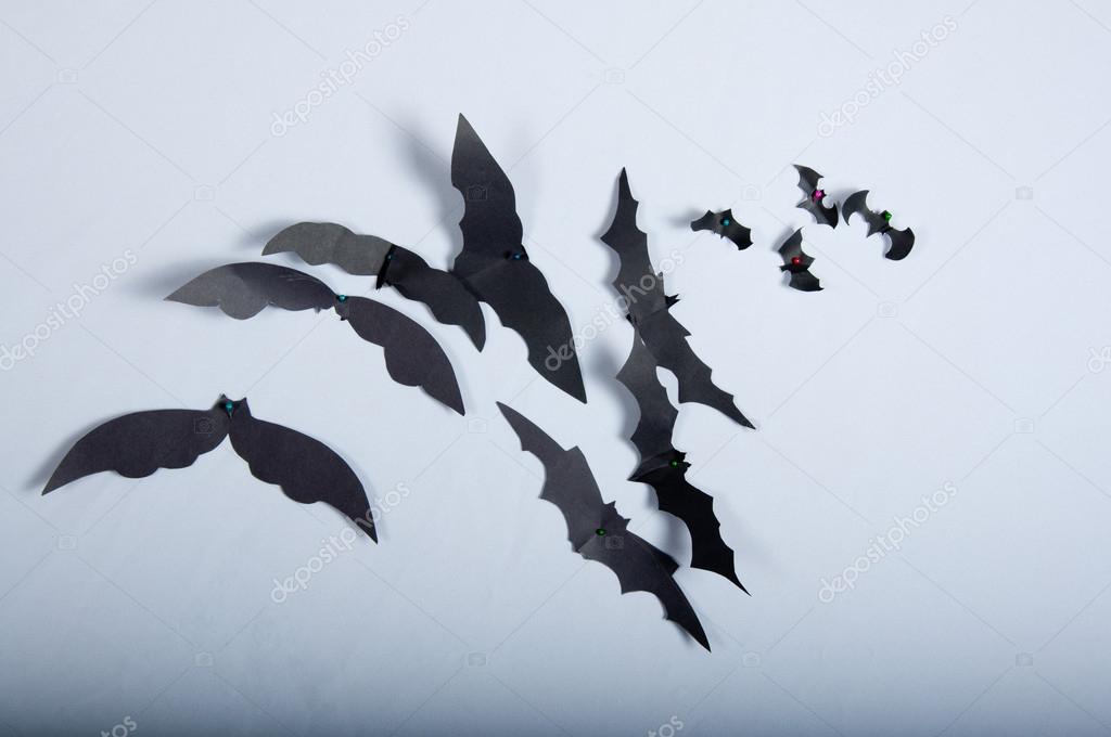 Paper bats on the white cloth