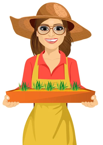 Młody rolnik kobieta w okularach przytrzymanie pudełko świeże zielone sadzonki roślin — Wektor stockowy