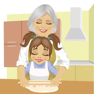 Büyükanne torunu hamur pizza mutfakta yemek için dışarı rulo kullanmayı öğretmek