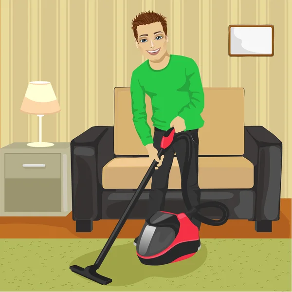 Homem jovem tapete de limpeza com aspirador de pó em casa — Vetor de Stock