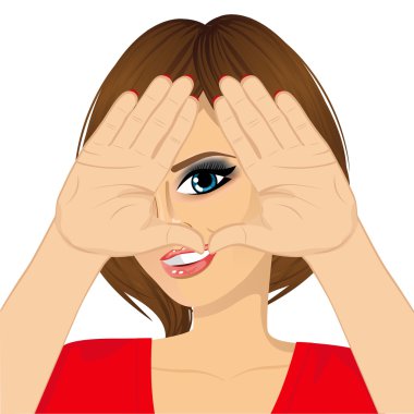 woman looking through triangle shape sign made with her hands