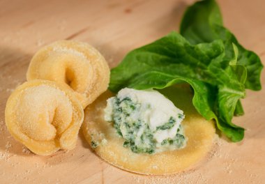 Italian homemade tortellini,open and closed,filled with ricotta cheese and fresh spinach. clipart