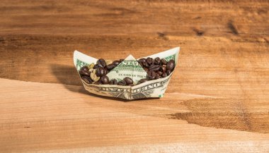 Boat banknote charge of coffee beans . clipart