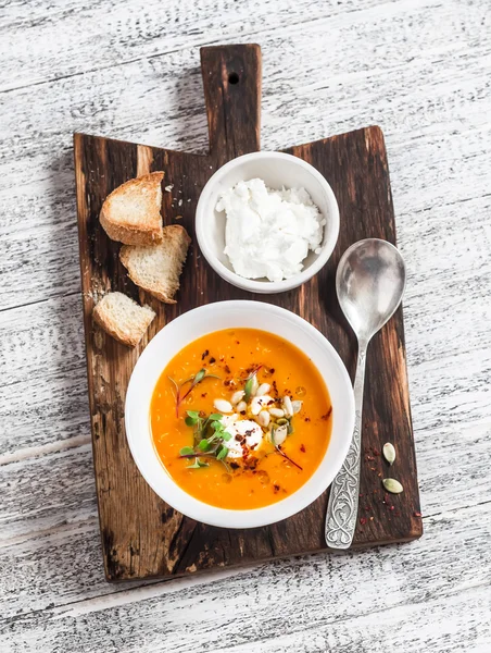 Healthy quinoa carrot soup with feta cheese, seeds and nuts on rustic light wooden board. Delicious vegetarian food — Stock Image Healthy quinoa carrot soup with feta cheese, seeds and nuts on rustic light wooden board. Delicious vegetarian food Stock Image