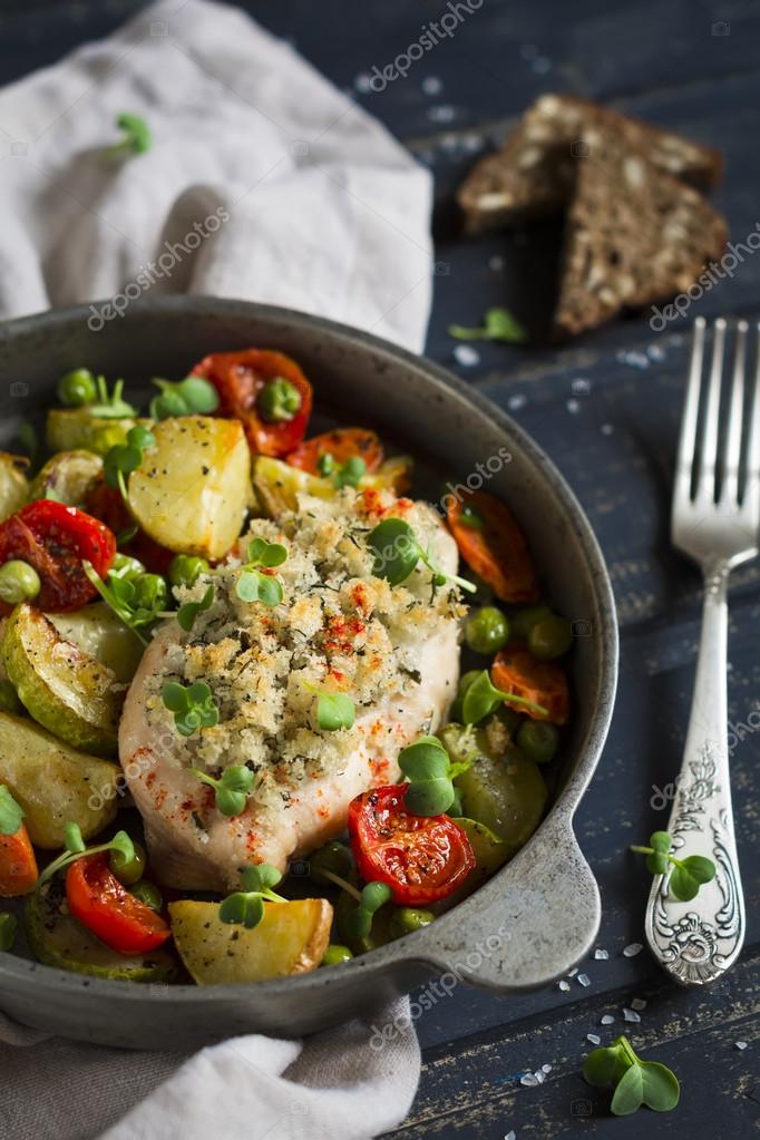 Chicken fillet with bread crumbs and baked vegetables in a vintage