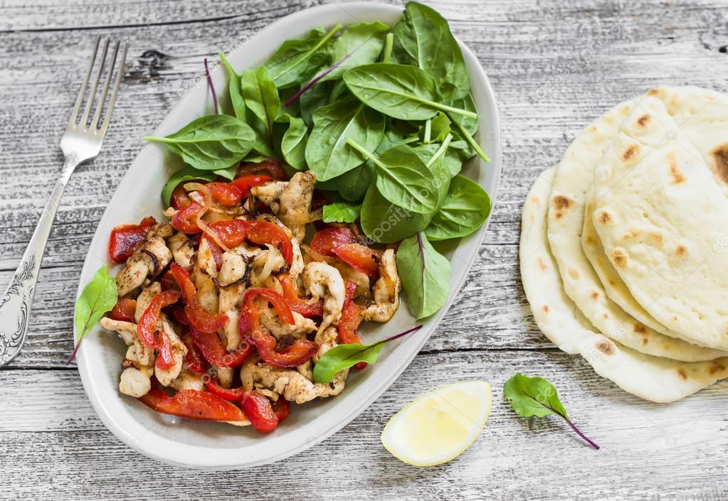 Stir fry of chicken breast and sweet red peppers, fresh spinach and