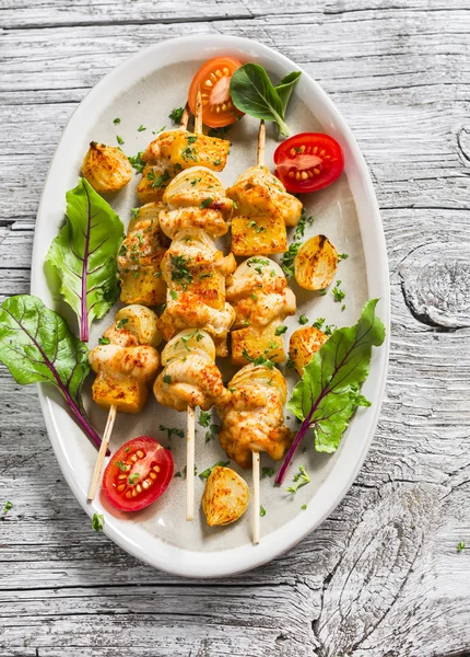 Chicken kebab with pumpkin and onions on a light wooden surface. — Stock Image Chicken kebab with pumpkin and onions on a light wooden surface. Royalty Free Stock Images