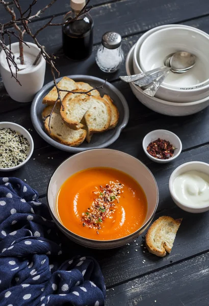 Roasted pumpkin soup in a ceramic bowl on dark wooden surface — Stock Image Roasted pumpkin soup in a ceramic bowl on dark wooden surface Stock Image