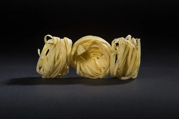 Pasta handmade on black background — Stock Photo, Image