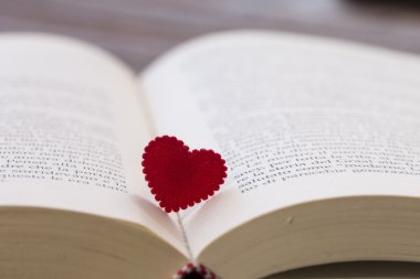 açık bir kitap arasında kırmızı kalp